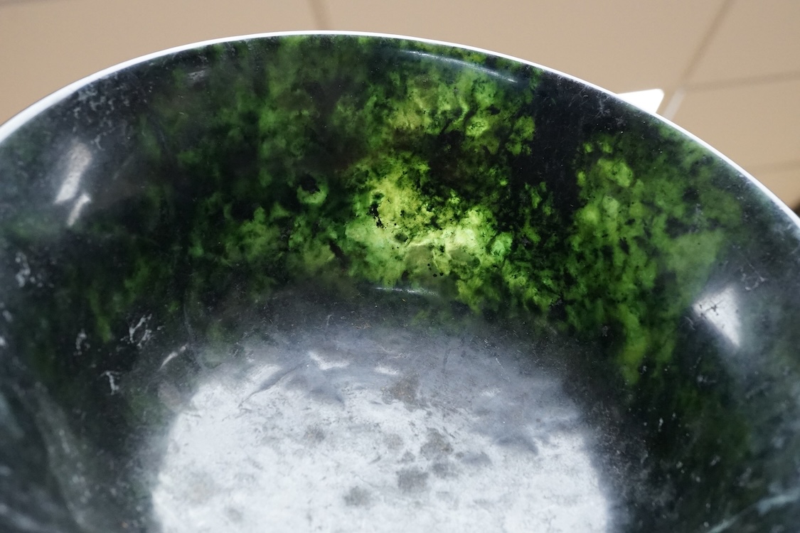 A Chinese spinach green jade bowl, 21cm diameter